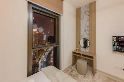 a room with a window with a view of a city at Walk to Dubai Mall and Burj Khalifa Luxury 2 Bed - sleep up to 10 in Dubai