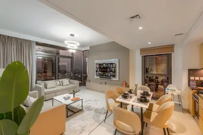 a living room with a couch and a table and chairs at Walk to Dubai Mall and Burj Khalifa Luxury 2 Bed - sleep up to 10 in Dubai