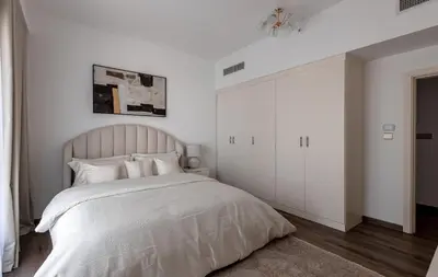 a white bedroom with a large bed and white cabinets at 2 bedroom with a full sea view ! BAHAR in Dubai