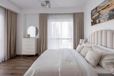 a white bedroom with a large bed and a window at 2 bedroom with a full sea view ! BAHAR in Dubai