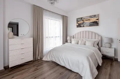 a white bedroom with a large bed and a mirror at 2 bedroom with a full sea view ! BAHAR in Dubai