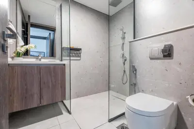 a bathroom with a shower and a toilet and a sink at GuestReady - Dubai Skyline & Canal View | 1 BHK in Dubai