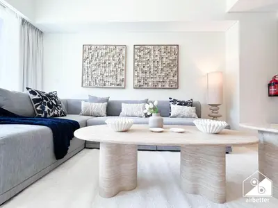 a living room with a couch and a coffee table at Luxurious 1BR with Balcony & Premium Stay in Downtown in Dubai