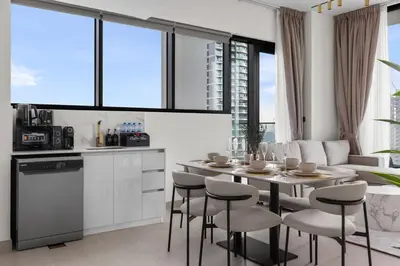 a kitchen and dining room with a table and chairs at Private Pool Retreat Chic 2BR Sleeps 8 in Dubai