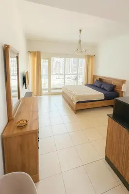a bedroom with a bed and a television in it at Cozy Studio at walking distance from Burj Khalifa and Downtown Dubai in Dubai