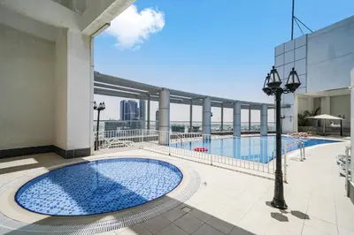 a swimming pool on the roof of a building at Cozy Studio at walking distance from Burj Khalifa and Downtown Dubai in Dubai