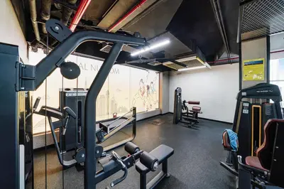 a gym with cardio equipment in a building at Cozy Studio at walking distance from Burj Khalifa and Downtown Dubai in Dubai