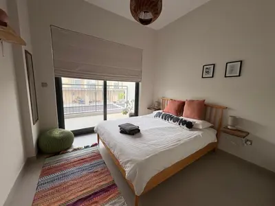 a bedroom with a bed and a large window at Bright & Stylish 4BR Villa in Dubai