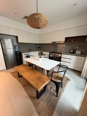 a kitchen with a table and a bench in it at Bright & Stylish 4BR Villa in Dubai