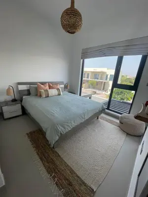 a bedroom with a bed and a large window at Bright & Stylish 4BR Villa in Dubai