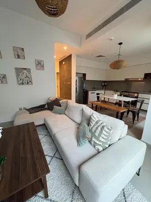 a living room with a white couch and a table at Bright & Stylish 4BR Villa in Dubai