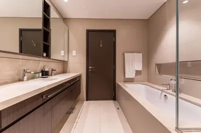 a bathroom with two sinks and a bath tub at HAVN - 2 bedroom in Downtown Views Dubai in Dubai