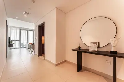 a hallway with a large mirror and a table at HAVN - 2 bedroom in Downtown Views Dubai in Dubai