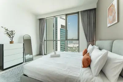 a bedroom with a large bed with a large window at HAVN - 2 bedroom in Downtown Views Dubai in Dubai