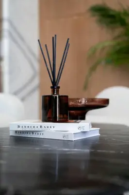 a book sitting on top of a table with sticks at Stylish High-Floor Studio in Binghatti Azure! in Dubai