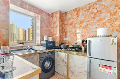 a kitchen with a refrigerator and a sink at FIRST CLASS Studio Cozy Marble Elegance in Dubai