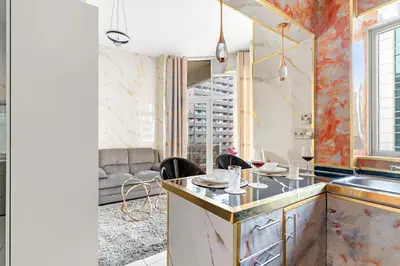 a kitchen with a counter and a sink in a room at FIRST CLASS Studio Cozy Marble Elegance in Dubai