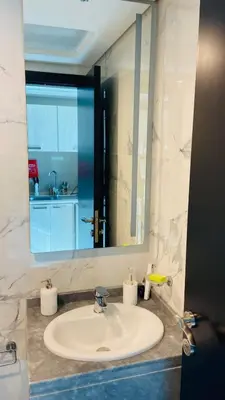 a bathroom with a sink and a large mirror at Studio in May 5 Boulevard in Dubai