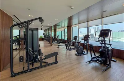 a gym with treadmills and exercise equipment in a building at Fully Furnished I Circle Mall I Sleeps 4 in Dubai