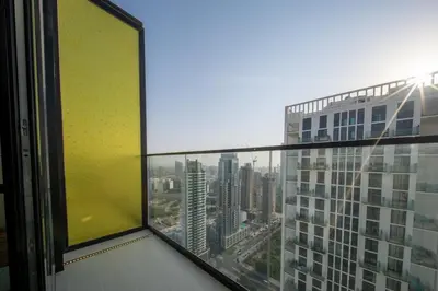 a view of a city from an office window at Sleeps 4 I Pool I Circle Mall I Epic Pool in Dubai