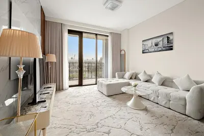 a living room with a couch and a table at FIRST CLASS 1BR Creek Beach & Lagoon Escape in Dubai