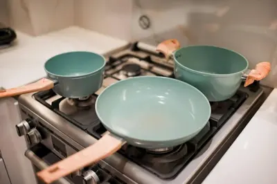 two pots sitting on top of a stove at Apartment in Binghatti Crescent, Next to Circle Mall in Dubai