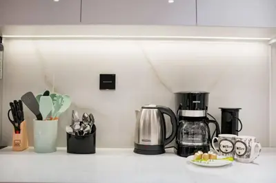 a kitchen counter with a coffeemaker and a coffee maker at Apartment in Binghatti Crescent, Next to Circle Mall in Dubai