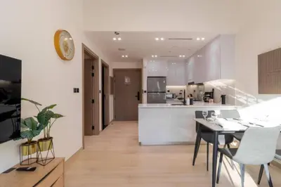 a kitchen and dining room with a table and chairs at Apartment in Binghatti Crescent, Next to Circle Mall in Dubai