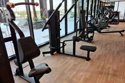 a gym with rows of treadmills and exercise bikes at Apartment in Binghatti Crescent, Next to Circle Mall in Dubai