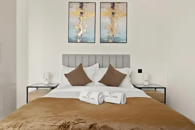 a bedroom with a large bed with two pillows at FIRST CLASS 3BR Luxury Meets Tranquility in Dubai