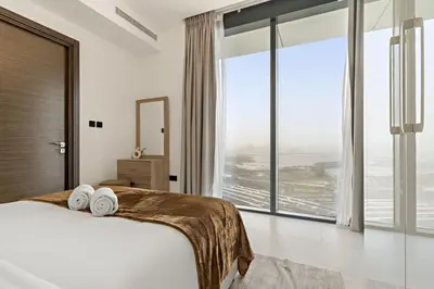 a bedroom with a bed and a large window at FIRST CLASS 3BR Luxury Meets Tranquility in Dubai