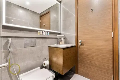 a bathroom with a toilet and a sink at Bookable 2 Bed Crest Sobha Hartland with Burj view in Dubai