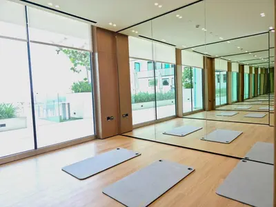 a row of yoga mats in a room with mirrors at Royalton - Modern JVC Studio Escape in Dubai