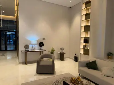 a living room with a couch and a chair at Azizi 205 Fully Furnished Apartment in Dubai