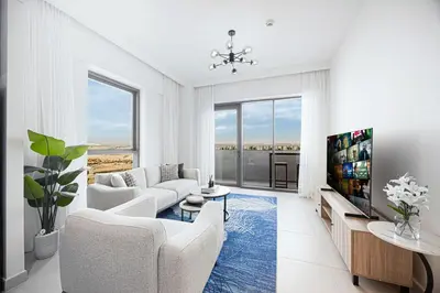 a living room with white furniture and a flat screen tv at Daniels 1BR at Bayshore 4 Creek Beach in Dubai