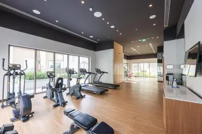 a gym with treadmills and cardio machines in a room at Daniels 1BR at Bayshore 4 Creek Beach in Dubai