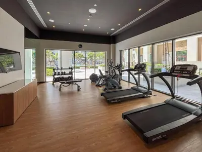 a gym with several treadmills and elliptical machines at Daniels 1BR at Bayshore 4 Creek Beach in Dubai