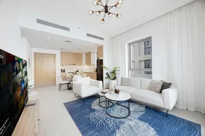 a living room with a couch and a table at Daniels 1BR at Bayshore 4 Creek Beach in Dubai