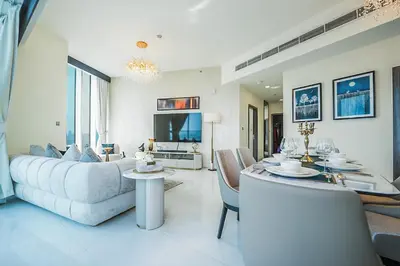 a living room with a couch and a table at EasyGo - Elegant 2 Bedroom near Miracle Garden in Dubai