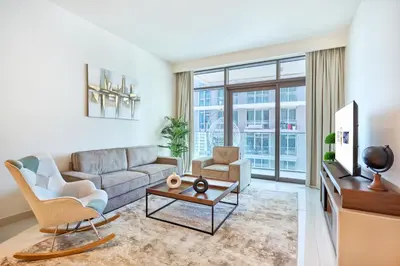 a living room with a couch and a tv at Beach Vista - Stunning Sea View in Dubai