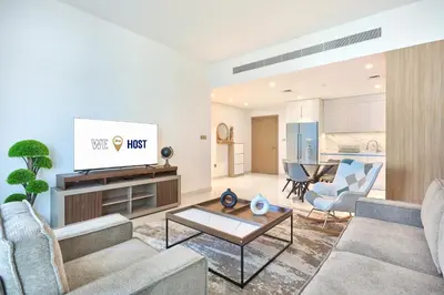 a living room with a couch and a tv at Beach Vista - Stunning Sea View in Dubai