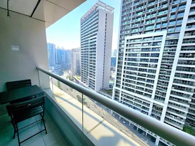 a balcony with a grand piano on a building at Chic Studio close to Dubai Mall with Canal Views in Dubai