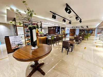 a restaurant with a table with a vase of flowers on it at Chic Studio close to Dubai Mall with Canal Views in Dubai