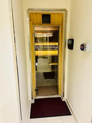 a hallway with a glass door to a closet at Chic Studio close to Dubai Mall with Canal Views in Dubai