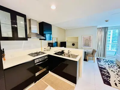 a kitchen with a sink and a stove at Chic Studio close to Dubai Mall with Canal Views in Dubai