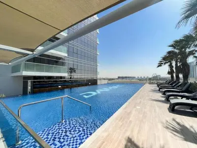 a swimming pool on the side of a building at Vacationer I Luxury Studio I Scenic Golf Course & Skyline Views I Carson B Tower in Dubai Marina
