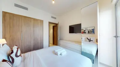 a white bedroom with a bed and a bath tub at Vacationer l Luxury Comfort 2 Bed Villa with Garden & Garage I Motor City in Dubai