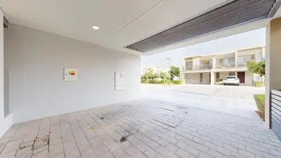 an empty room with white walls and a parking lot at Vacationer l Luxury Comfort 2 Bed Villa with Garden & Garage I Motor City in Dubai