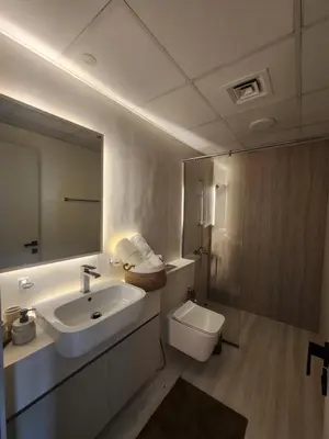 a bathroom with a sink and a toilet and a mirror at City View Apartment 5 min to Downtown and 5 min to World Trade Center DIFC in Dubai
