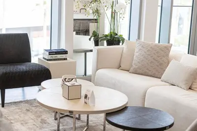 a living room with a white couch and a table at Luxury 3 Bedroom Apartment in Bluewaters Residences in Dubai